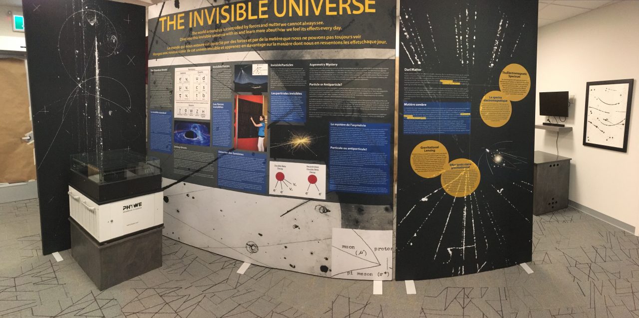 The cloud chamber sits next to an informational display titled 