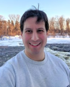 Shawn Westerdale is shown smiling in a headshot taken in the snowy outdoors