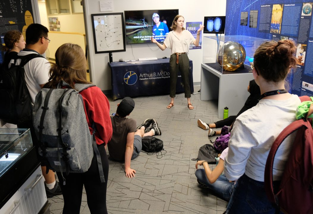 A scientist talks to a group in the MI Visitor Centre.