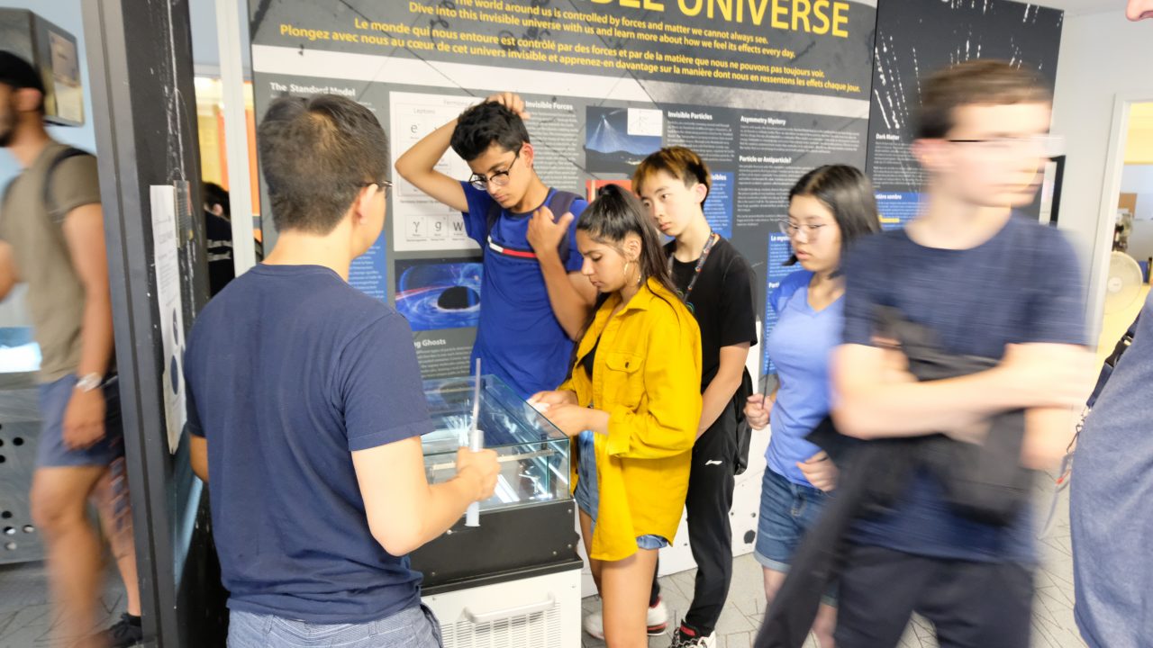 Students watch particle trails in the Cloud Chamber Particle Detector, available on display at the MI Visitor Centre.