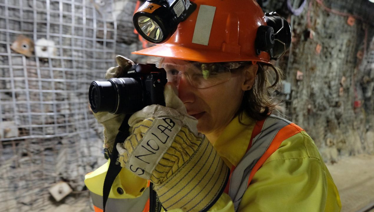 Artist Nadia Lichtig photographing the drift entrance to SNOLAB.