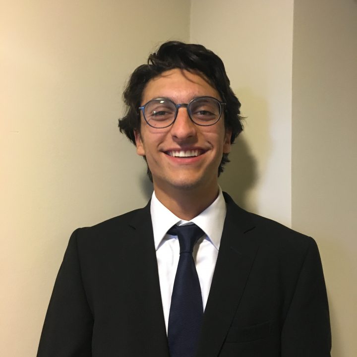 Gearges Kanaan is shown smiling in a headshot, wearing a suit and tie