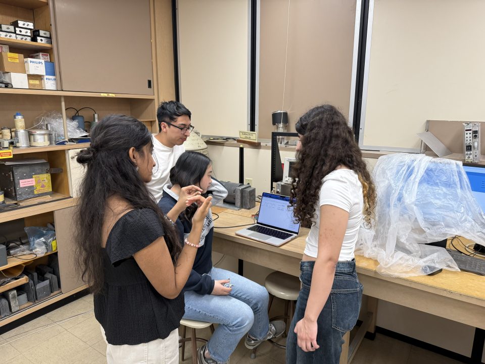 Undergraduate Students at CAPPS work in a small group on particle shielding experiment.