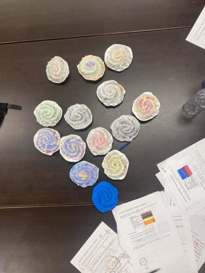Classroom galaxy craft models displayed with worksheets.